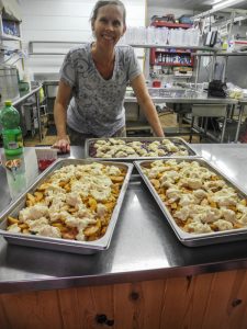 Baker making cobbler at Camp Blue Spruce